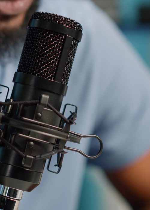 Close up of black vlogger using microphone on podcast Close up of black vlogger using microphone on podcast